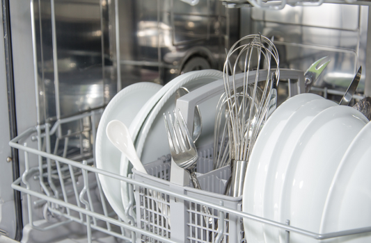 Clean sparkling dishes in a dishwasher. Cover image for a blog  A simple Rinse Aid recipe for your  Dishwasher