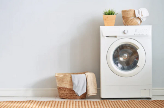 A clean rustic laundry with washing machine and laundry baskets. This natural image is the cover for a blog on how to make your own natural powder that is ecofriendly and better for those with sensitivities.  