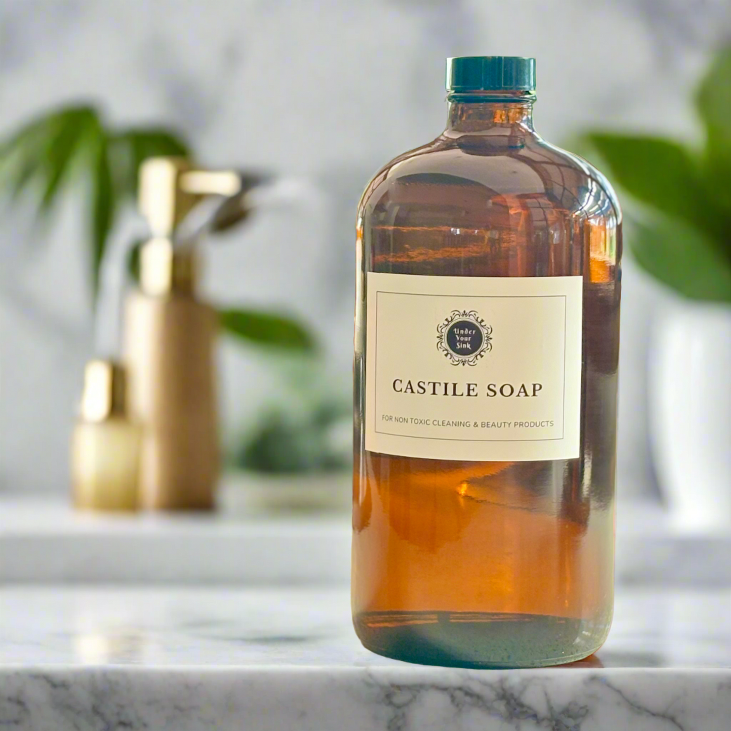 An amber glass bottle with a white label with Under your Sink Logo and description Castile Soap – For non toxic cleaning and beauty products. The bottles are set in a kitchen with a blurred background for effect. It is a product image for website as this is for sale in various sizes, online with Australia wide delivery.
