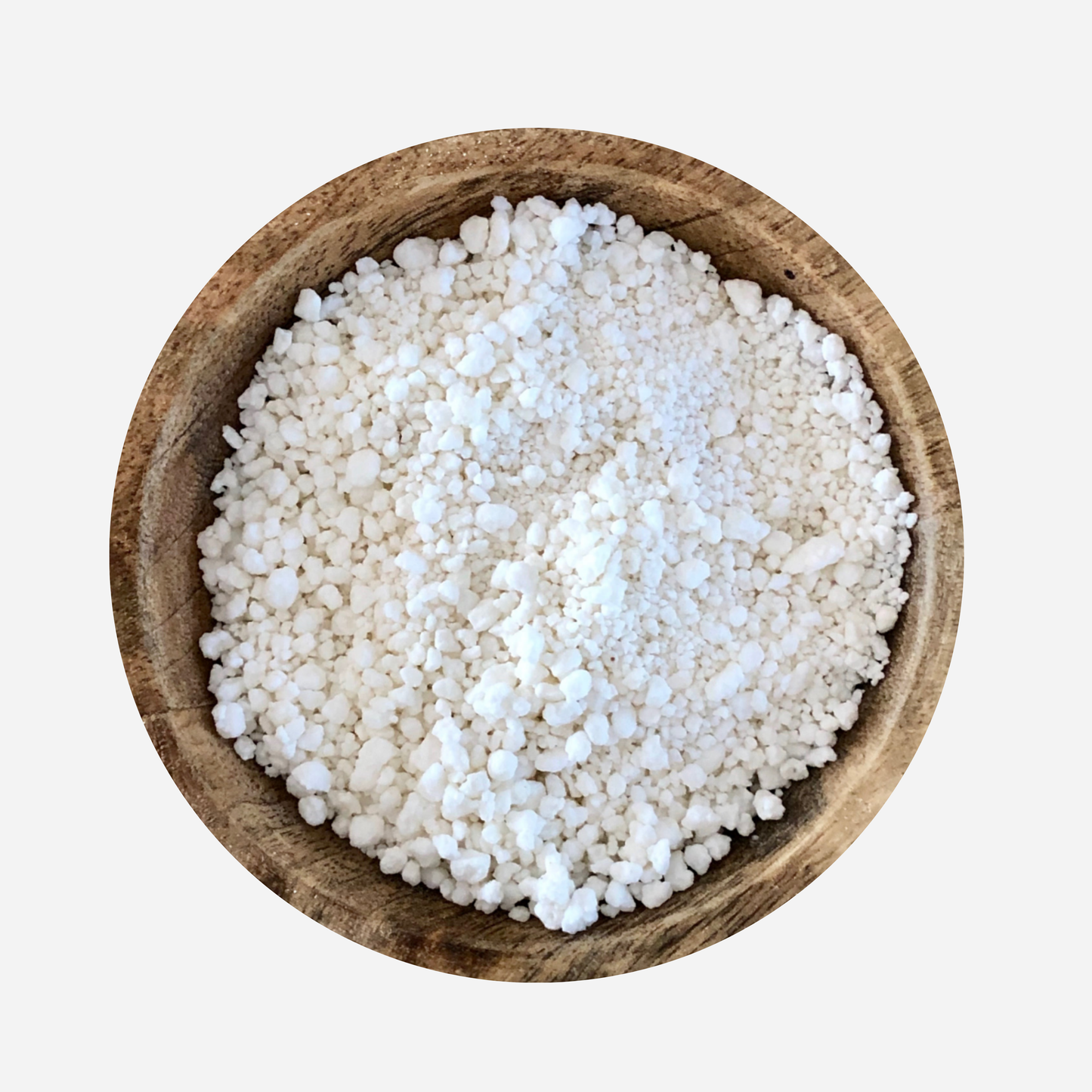 organic coconut soap flakes in a wooden bowl. White grated coconut soap for natural cleaning and DIY laundry washing powder