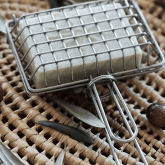 Metal cage with handle used to hold a soap bar to swish in sink for plastic free, zero waste green cleaning