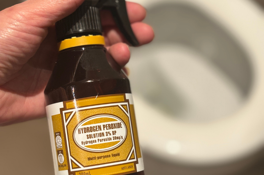 Bottle of hydrogen peroxide 3% above a toilet for cleaning