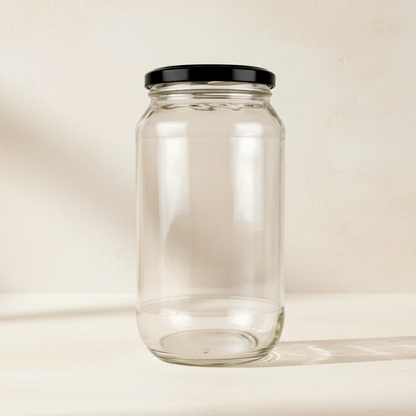A clear glass jar with a black screw-on lid, shown against a plain white background.
