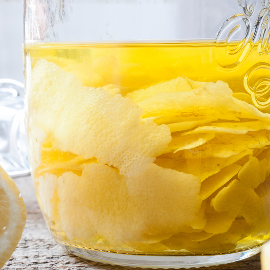 clear glass jars with lemon rinds and vinegar for cleaning