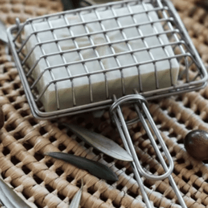 Metal cage with handle used to hold a soap bar to swish in sink for plastic free, zero waste green cleaning